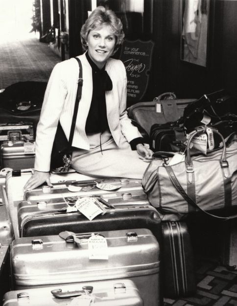 Anne sitting on luggage before leaving for Australia