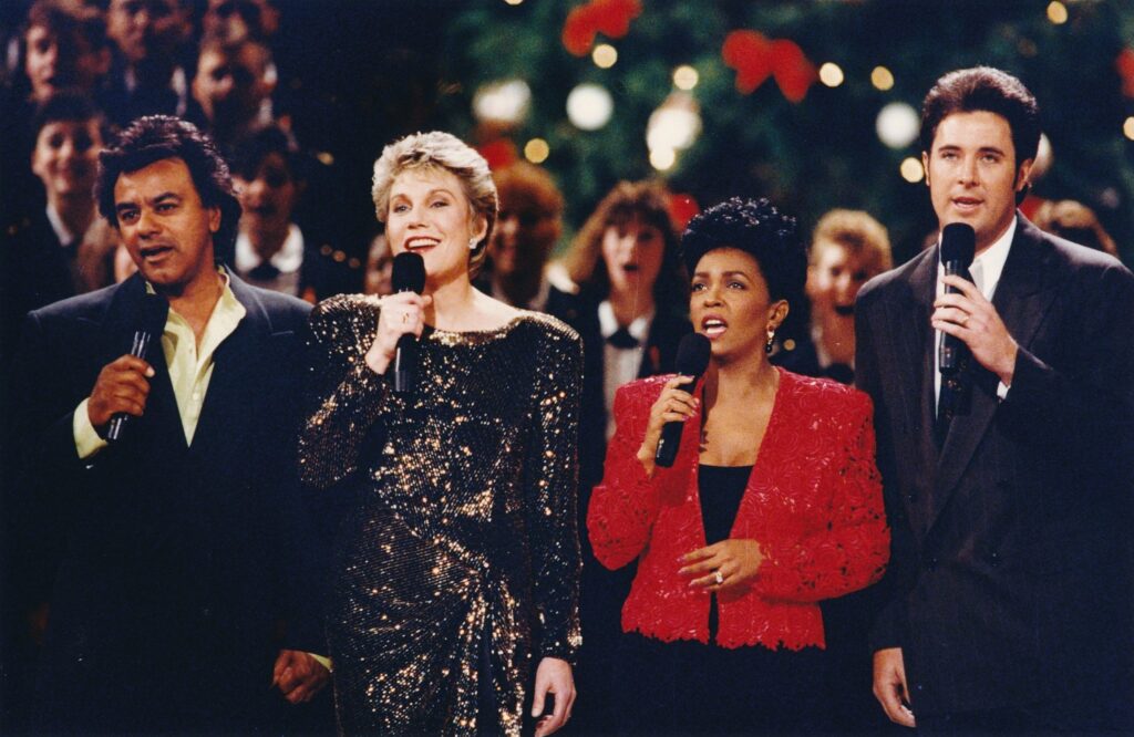 . Anne on stage at Christmas in Washington with Johnny Mathis, Anita Baker, and Vince Gill